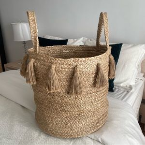 Woven basket with handles and tassels